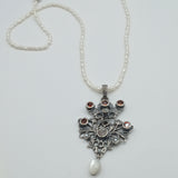 Austro-Hungarian style, adorned with mother-of-pearl natural pearl and garnet pendant