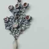 Austro-Hungarian style, adorned with mother-of-pearl natural pearl and garnet pendant