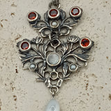 Austro-Hungarian style, adorned with mother-of-pearl natural pearl and garnet pendant