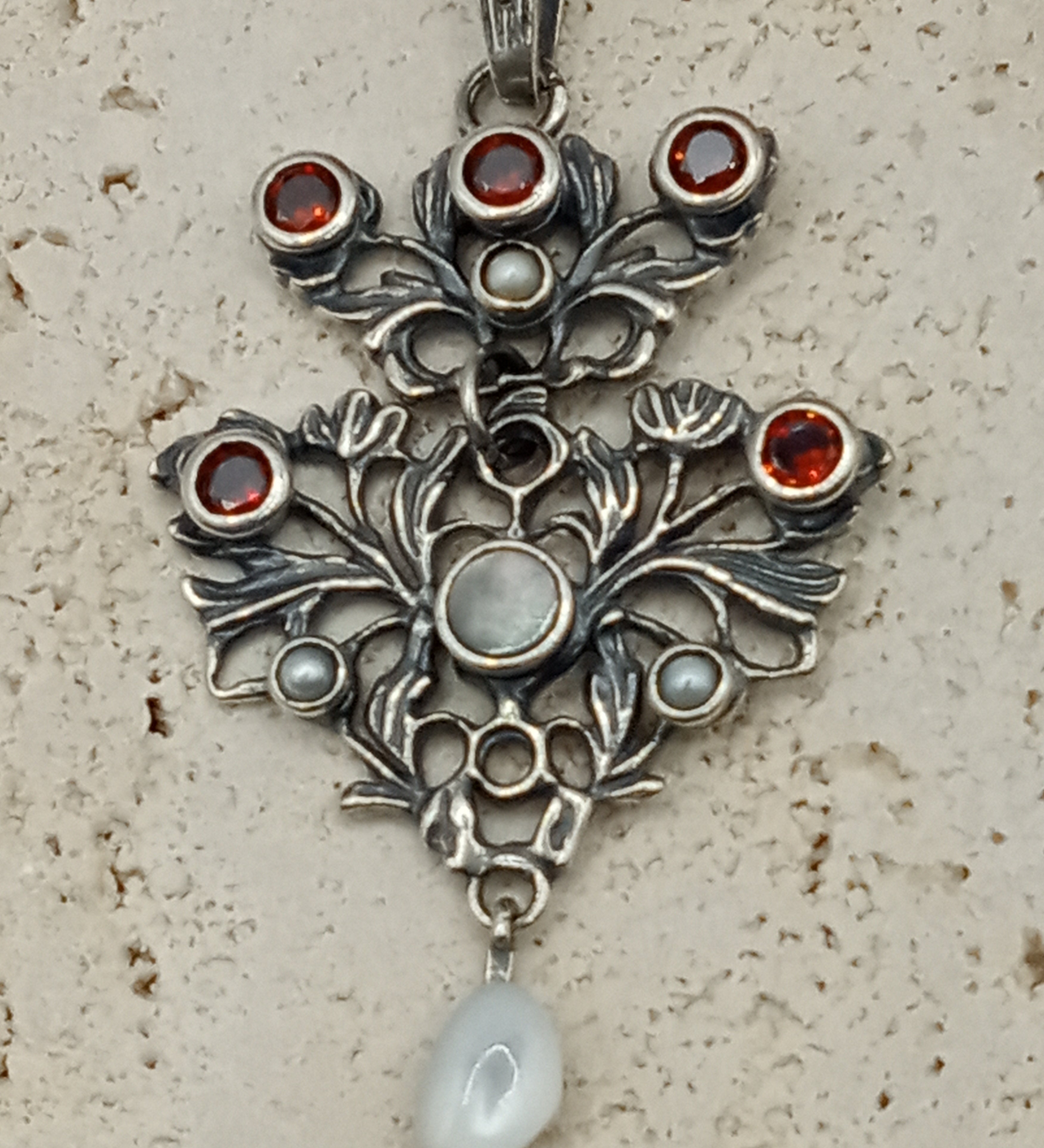 Austro-Hungarian style, adorned with mother-of-pearl natural pearl and garnet pendant