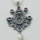 Austro-Hungarian style, adorned with mother-of-pearl natural pearl and garnet pendant
