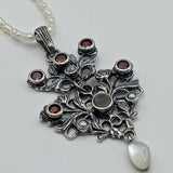 Austro-Hungarian style, adorned with mother-of-pearl natural pearl and garnet pendant