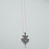 Austro-Hungarian style, adorned with mother-of-pearl natural pearl and garnet pendant