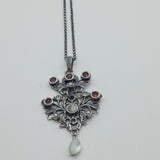 Austro-Hungarian style, adorned with mother-of-pearl natural pearl and garnet pendant