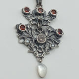 Austro-Hungarian style, adorned with mother-of-pearl natural pearl and garnet pendant